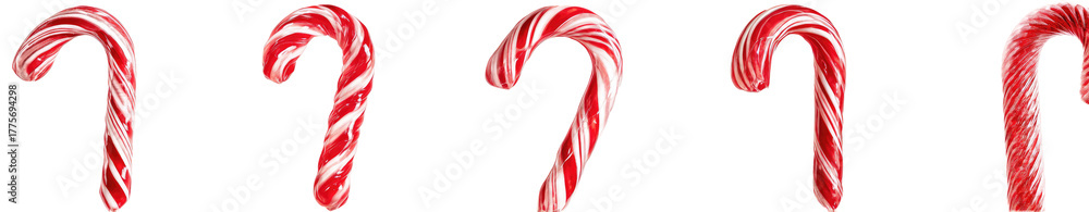 Fototapeta premium Four candy canes in red and white stripes against a black background