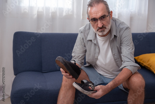 Elderly man wearing mismatched shoes, symbolizing confusion, memory loss, or early signs of dementia and Alzheimer’s. Useful for mental decline, senior health, and aging awareness topics.