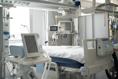 Hospital intensive care unit with medical equipment and bed