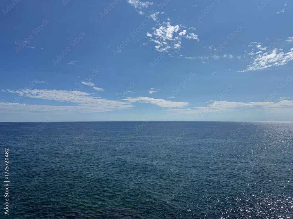 Fototapeta premium Open sea calm water and blue sky horizon.