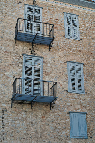Historic stone building with blue shutters in Nafplio, Peloponnese, Greece