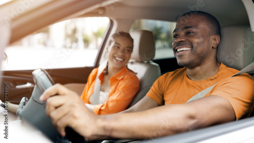 Cuadro en lienzo Happy young black couple enjoying relaxed moment while driving car together, afr