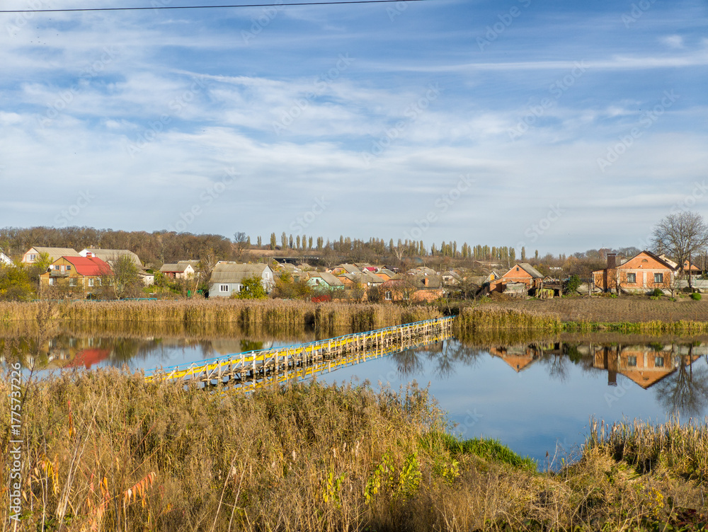 Fototapeta premium A small bridge over a small lake in the middle of a small town