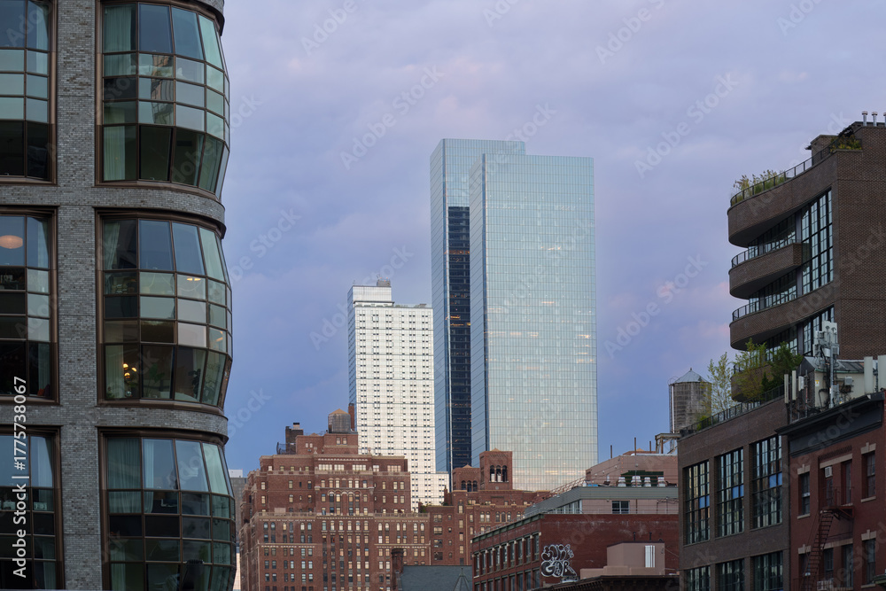 Fototapeta premium Low-angle view of modern skyscrapers in Manhattan, New York City. This dramatic perspective emphasizes the towering height and sleek design of the city's contemporary architecture. 