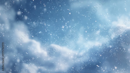 Winter snowfall against a soft blue sky with fluffy clouds and white flakes