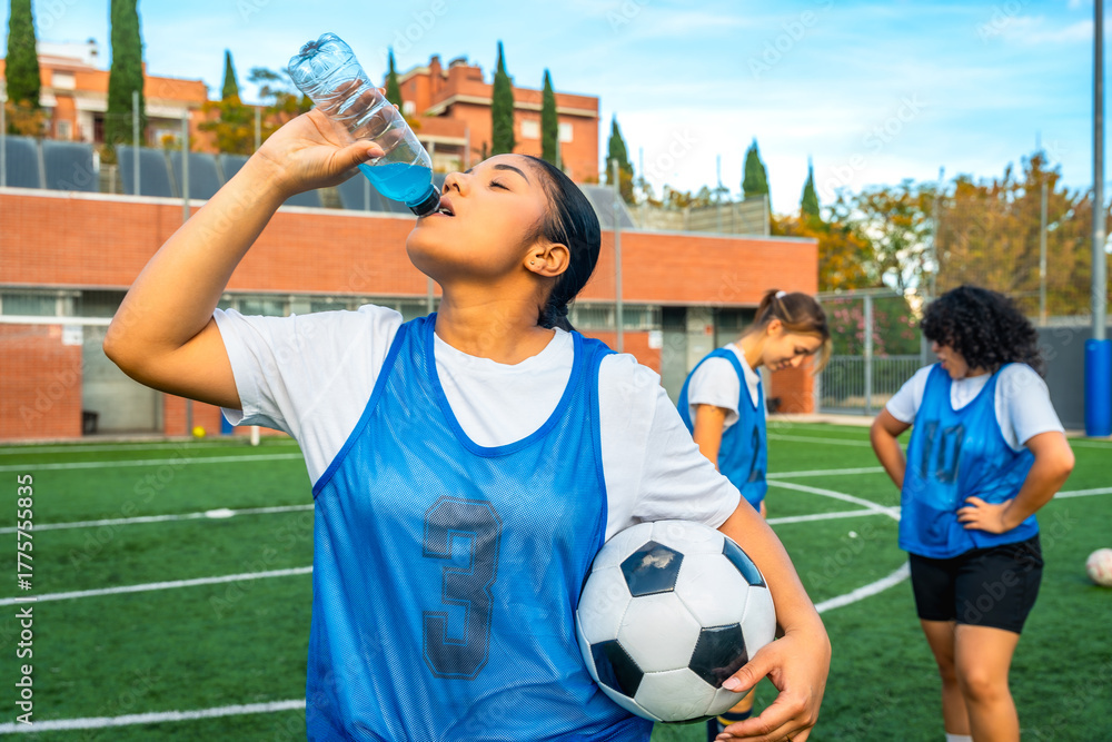 Ταπετσαρία Female soccer player hydrating with sports drink on field