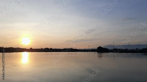Sunrise in the mangrove forest near the sea and settlements with mountains in the background on the right