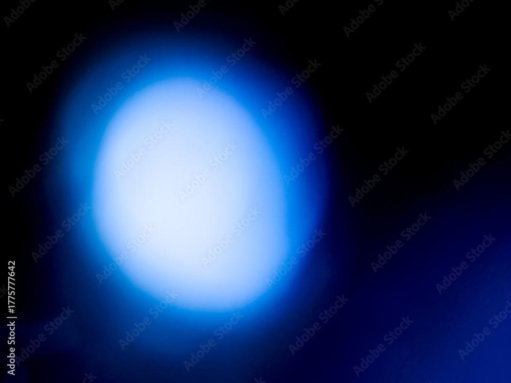Obraz premium Blue color light leaks on a dark background. Colorful burst of light for design or special effects.