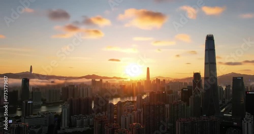 Vibrant sunset over a bustling city skyline with clouds