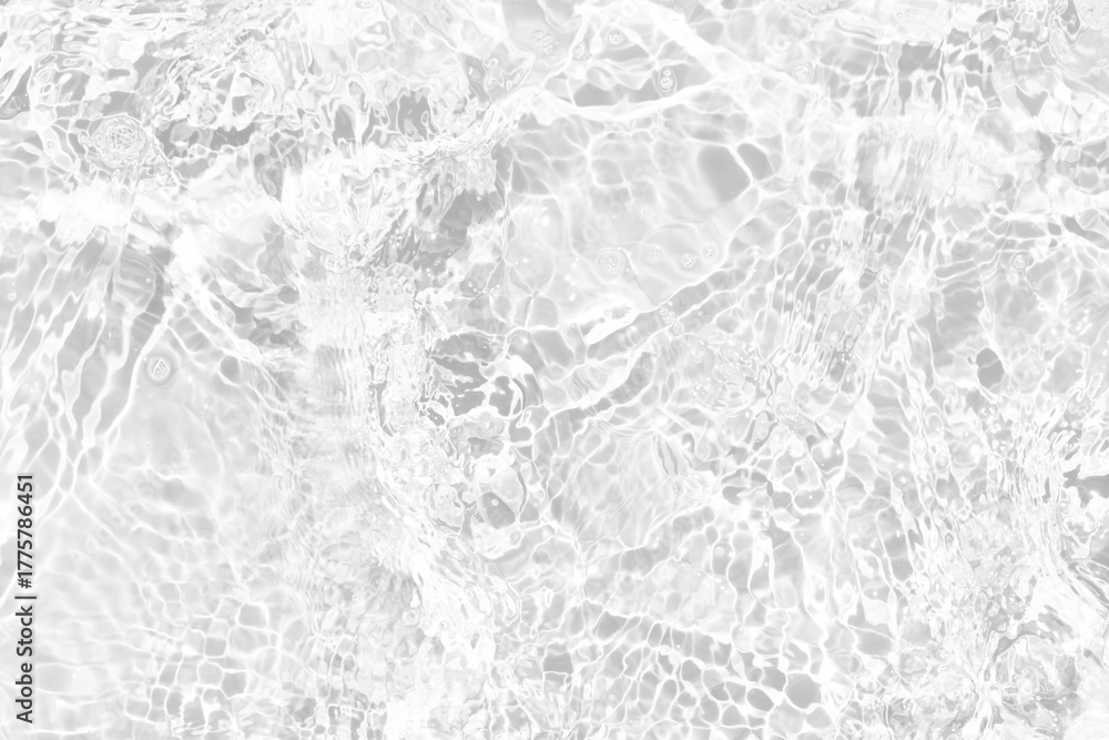 Naklejka premium White water with ripples on the surface. Defocus blurred transparent white colored clear calm water surface texture with splashes and bubbles. Water waves with shining pattern texture background.
