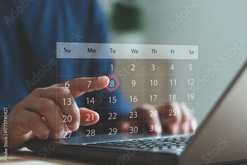 Foto Business person using a laptop and touching a digital calendar interface, selecting a date for scheduling, event planning or time management in modern online productivity applications