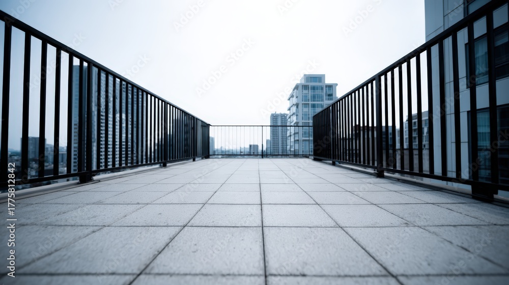 Obraz premium Rooftop Balcony View with Cityscape, Modern Architecture, and Geometric Tile Pattern on a Cloudy Day