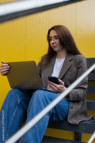Modern Woman Working Outdoors with Laptop – Urban Freelance Lifestyle