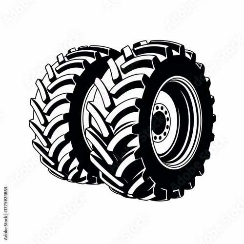 Two large tractor tires with deep treads on a white background