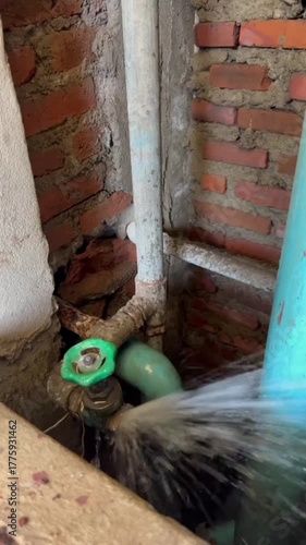 Wallpaper Mural Plumber repairing a broken PVC water pipe with strong water leakage, maintenance and plumbing repair work in progress, fixing damaged water supply system, home repair and renovation concept. Torontodigital.ca