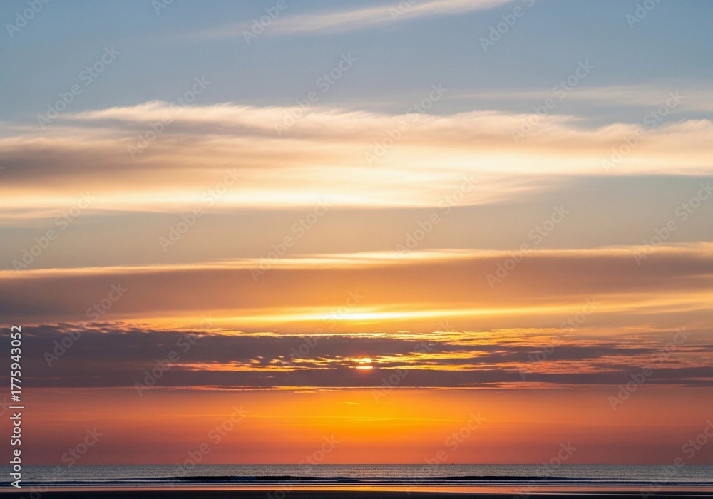 Obraz premium A stunning high-resolution photograph of a partly cloudy sky at sunrise. The horizon glows with soft pink, peach, and golden tones blending into a light blue upper sky. Fluffy, diffused clouds catch t