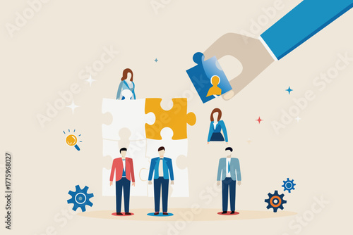 Hand placing a puzzle piece with a person icon into a larger puzzle representing team building and human resources