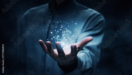 Mysterious man holding a glowing orb of shimmering particles symbolizing future technology
