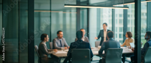 Business people meeting around a table in a modern office setting, collaborating on ideas and strategies under bright natural light that enhances teamwork and a professional atmosphere.
