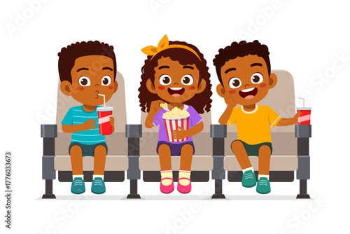 Three African American kids sitting in a movie theater chairs while watching a film eating snack