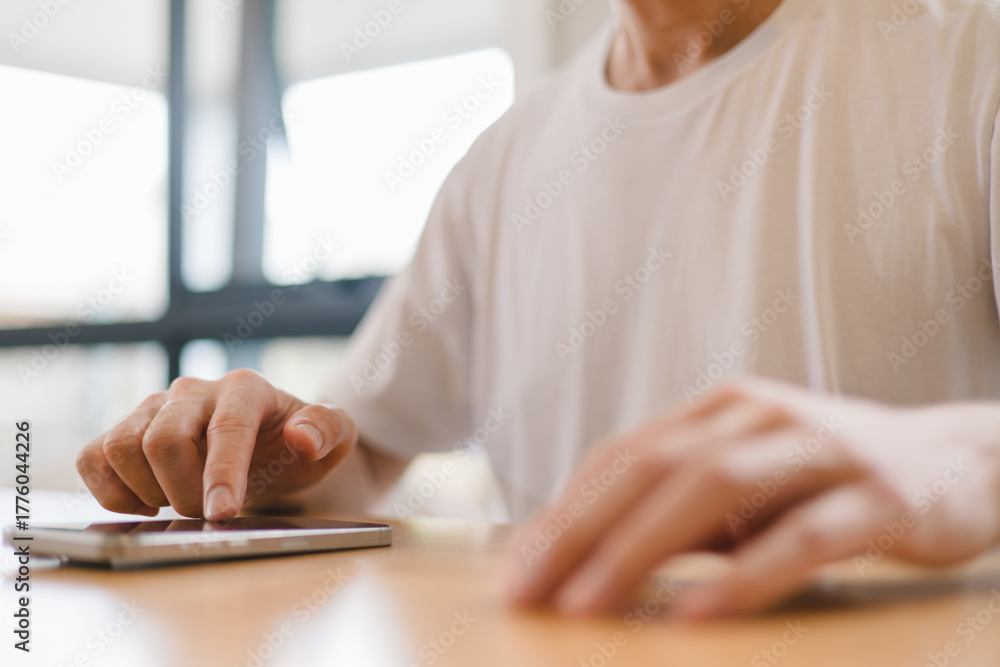 Fototapeta premium person using a modern smartphone indoors, emphasizing communication, technology daily digital lifestyle in a relaxed environment.
