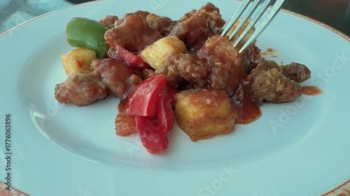 Eating a Plate of Sweet and Sour Chicken