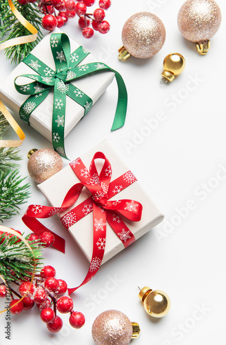 Christmas gifts decorations with holly and ornaments on white