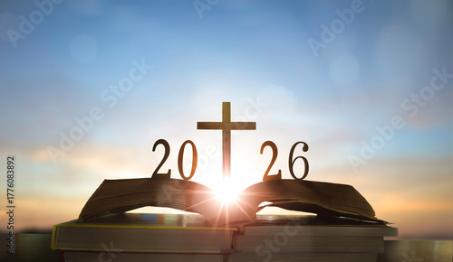 Happy new year 2026 and christian cross on the old book.