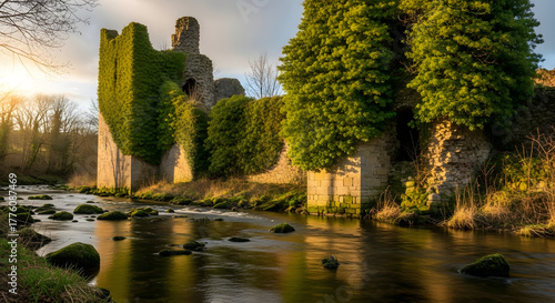 Picturesque ruins of a stone castle covered in ivy near a flowing river