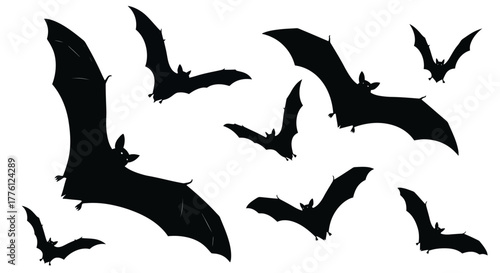 A group of bats are flying in the air, silhouetted against a white background.