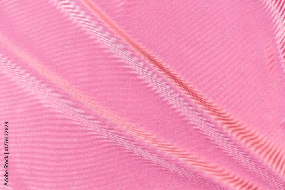 Fototapeta premium Shiny waving pink fabric texture background, abstract pink fabric pattern background