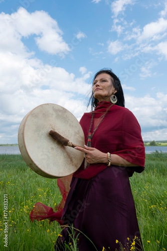 Portrait of a middle-aged shaman woman with a red headscarf