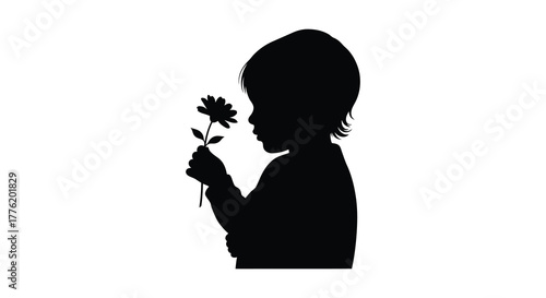 Silhouette of a young child holding a single flower capturing a moment of quiet contemplation and innocence