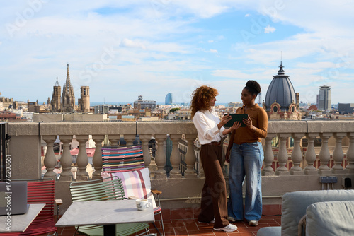 Photography Women collaborating on tablet at barcelona rooftop coworking