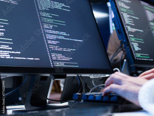 Close-up of Software developer hand typing on keyboard, writing code, developing app at tech office. Female computer programmer working on desktop computer development ai machine learning prompt.