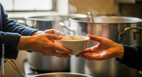 Close up volunteer hands giving warm food bowl to needy person in charity kitchen community support human kindness social care helping hands humanitarian aid soup distribution service soft light 