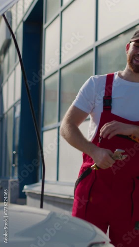 Car service worker uses wrench to fix faulty vehicle engine