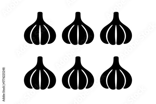 Six black garlic cloves arranged in a symmetrical pattern on a white background