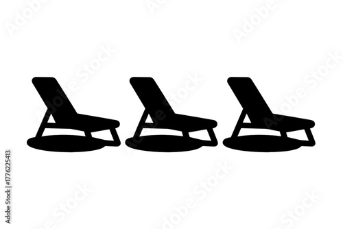 Empty lounge chairs in a serene setting near the beach during a sunny day invite relaxation and unwinding