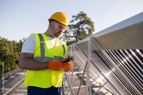 Engineer adjusting solar installation ensuring efficiency and safety