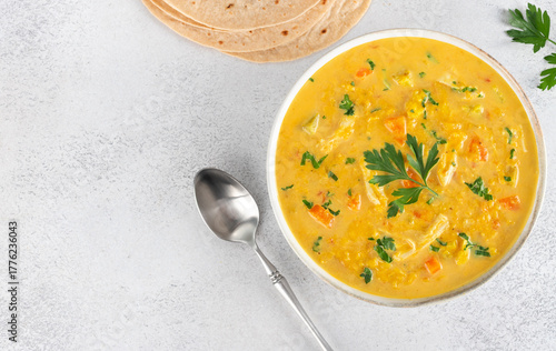 Mulligatawny soup with lentils vegetables with chapati flatbreads on white background. Top view. Copy space. Indian food