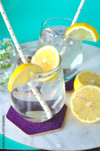 Lemon Water with Fresh Slieced Lemon on Background