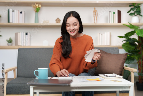 Tax preparation. Smiling woman organizing tax documents at home.