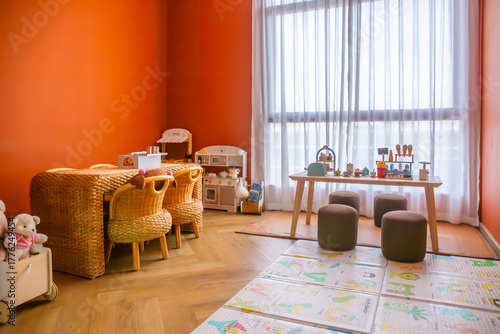 Children's playroom with wooden toys and non-toxic paints helps develop children with wooden tables and chairs.