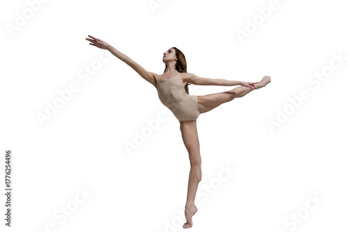 ballerina with beautiful feet poses in a photo studio, a ballerina in leotard shows an arabesque attitude