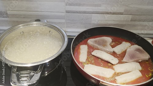 Boiling Pasta and Tomato Sauce Cooking on Kitchen Stove