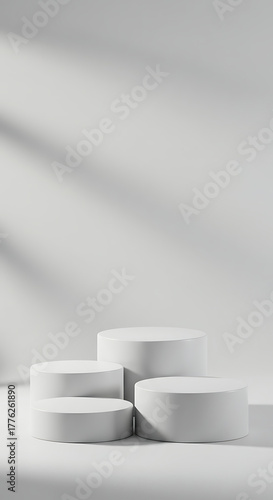 Four white round podiums isolated on white background for product display, a minimal, modern display platform (dais/pedestal) for product or presentation visuals