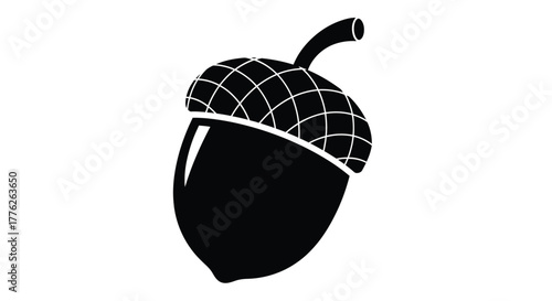 A simple black and white silhouette illustration of a single acorn with a textured cap and a short stem.