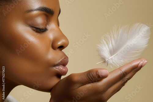 Captivating close-up of a woman's radiant skin with a delicate feather floating near her lips, embodying softness and purity for beauty and skincare campaigns.