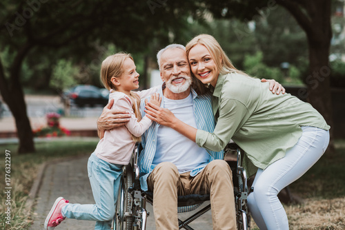 Bilde på lerret Joyful family embrace in park as grandpa in wheelchair shares love care and laug